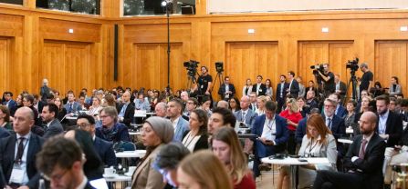 Audience Wide shot of participants in the plenary and press in the back