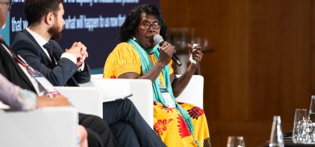 Helen Hakena (Co-founder, Leitana Nehan Women's Development Agency) Female speaker speaking into the mic at BCSC2024