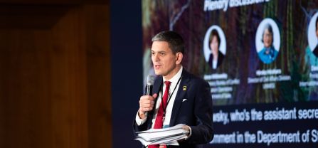 David Miliband (President and CEO, International Rescue Committee, IRC) introducing the third panel of the conference Male speaker speaking into mic at BCSC2024