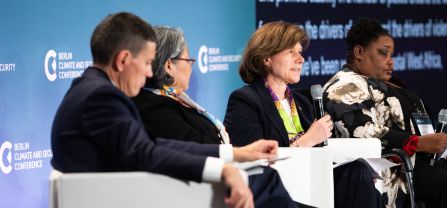 From left to right, David Miliband (President and CEO, International Rescue Committee, IRC), Hiroko Hirahara (Director of Civil Affairs Division, United Nations Mission in South Sudan, UNMISS), Anne Witkowsky (Assistant Secretary, Bureau of Conflict and Stabilization Operations of the United States Department of State), and Gerty Pierre (Climate Change Director, Ministry of Environment of Haiti) Female Speaker speaking into mic at BCSC2024